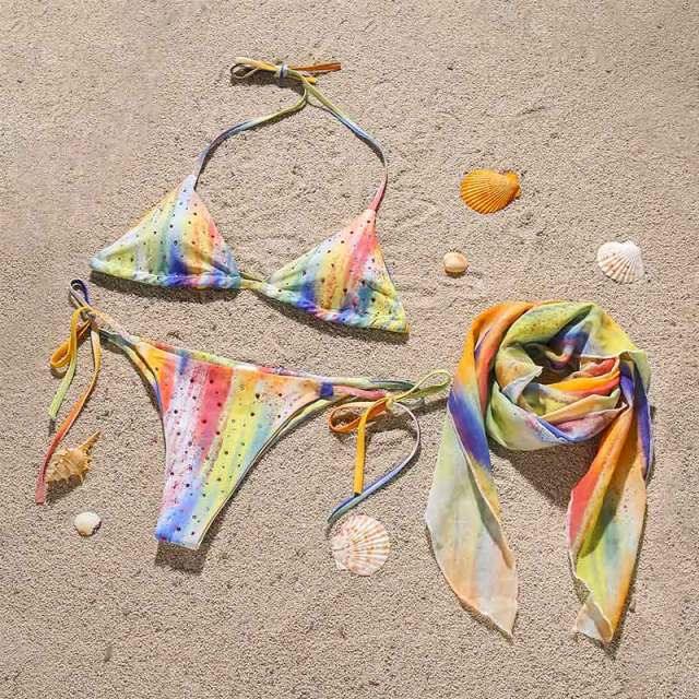 Stevvex 3-piece women's bikini set with high-cut design, halter top, wrap skirt, lace-up details, and backless triangle style.