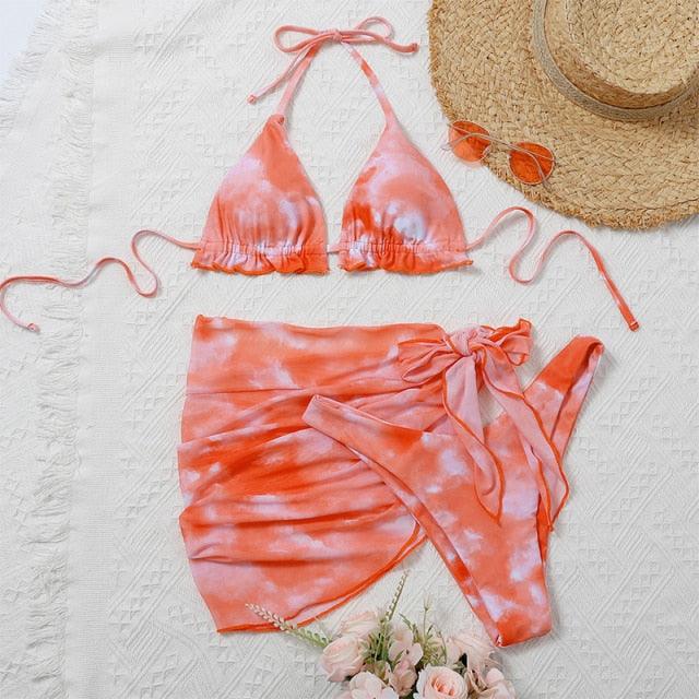 Stevvex 3-piece women's bikini set with high-cut bottoms, halter top, wrap skirt, lace-up details, backless design, and string ties.