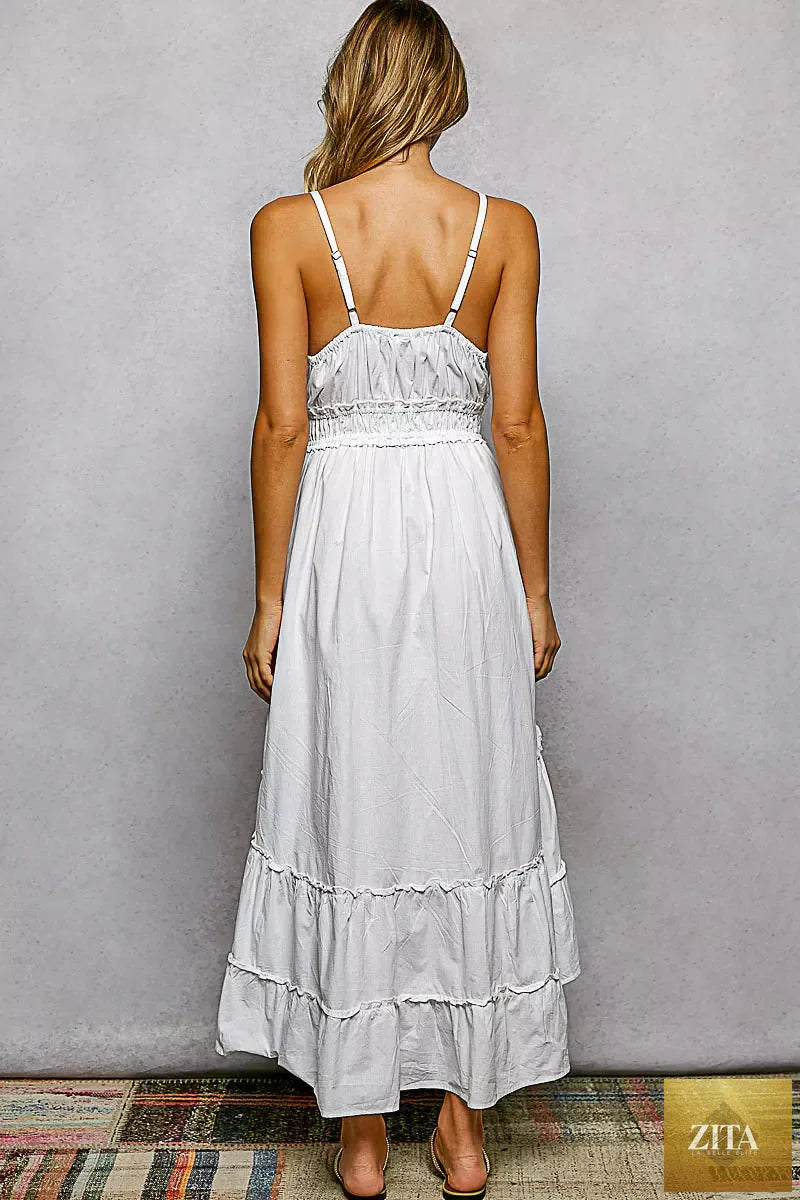 Blue midi cami dress with embroidered detail, tassel tie, smocked waist, and tiered skirt from Blu Lotus Boutique.