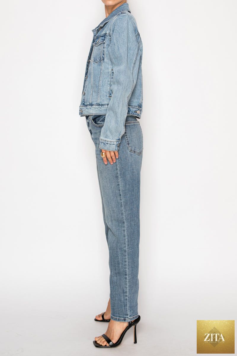 Artemis Vintage Michelle Classic Denim Jacket hanging on a rack, showcasing its blue denim fabric and stylish design.