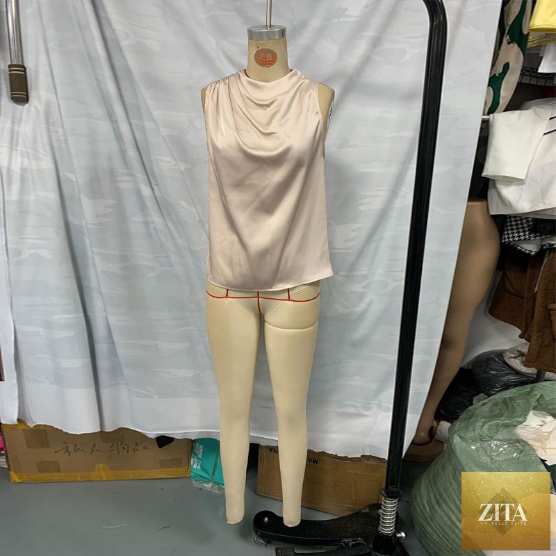 Women's elegant sleeveless mock neck top by FitiqueFit, casualwear style, shown in a neutral color on a model.