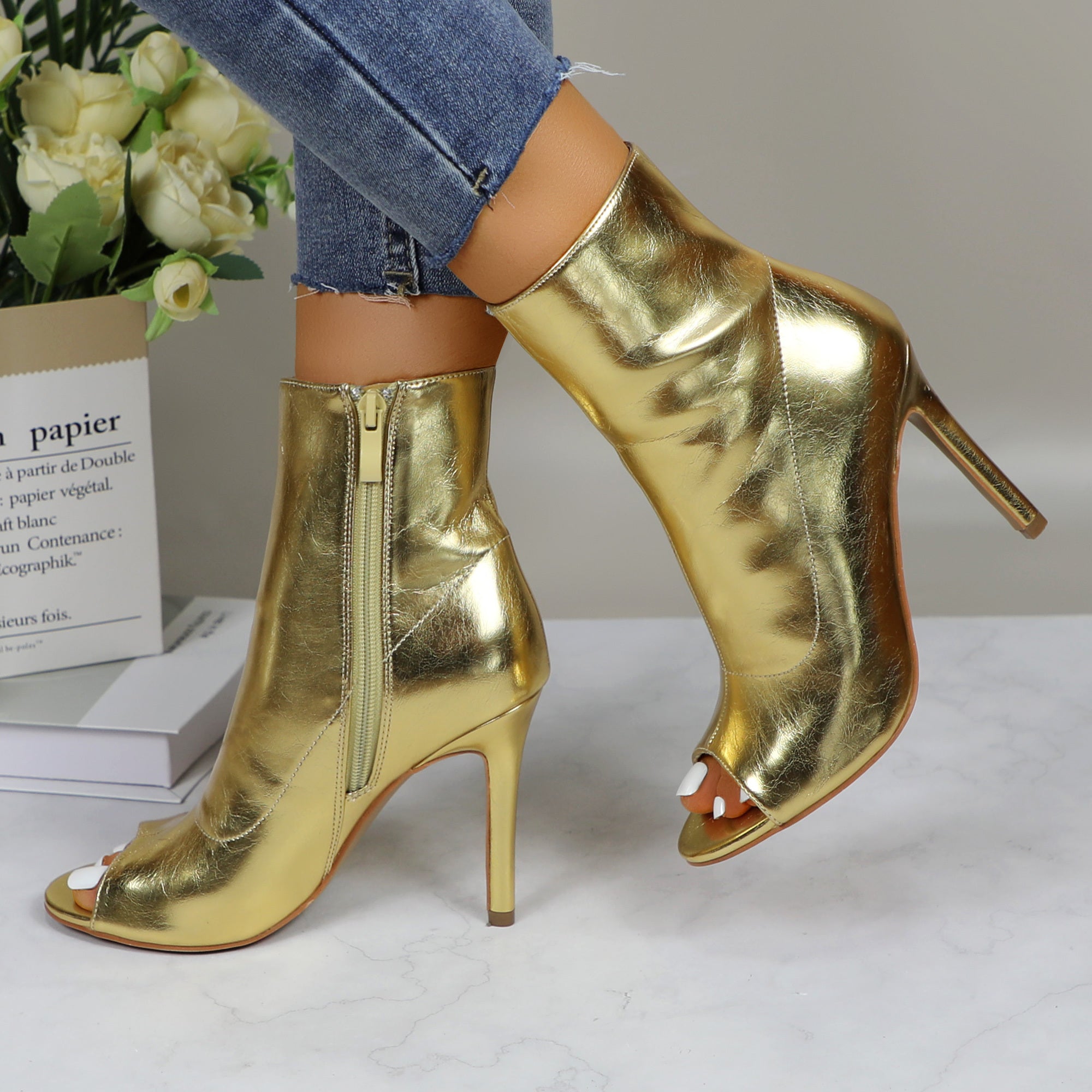 Shiny metallic stiletto boots for women, perfect for dance parties, with a sleek high heel and reflective finish.