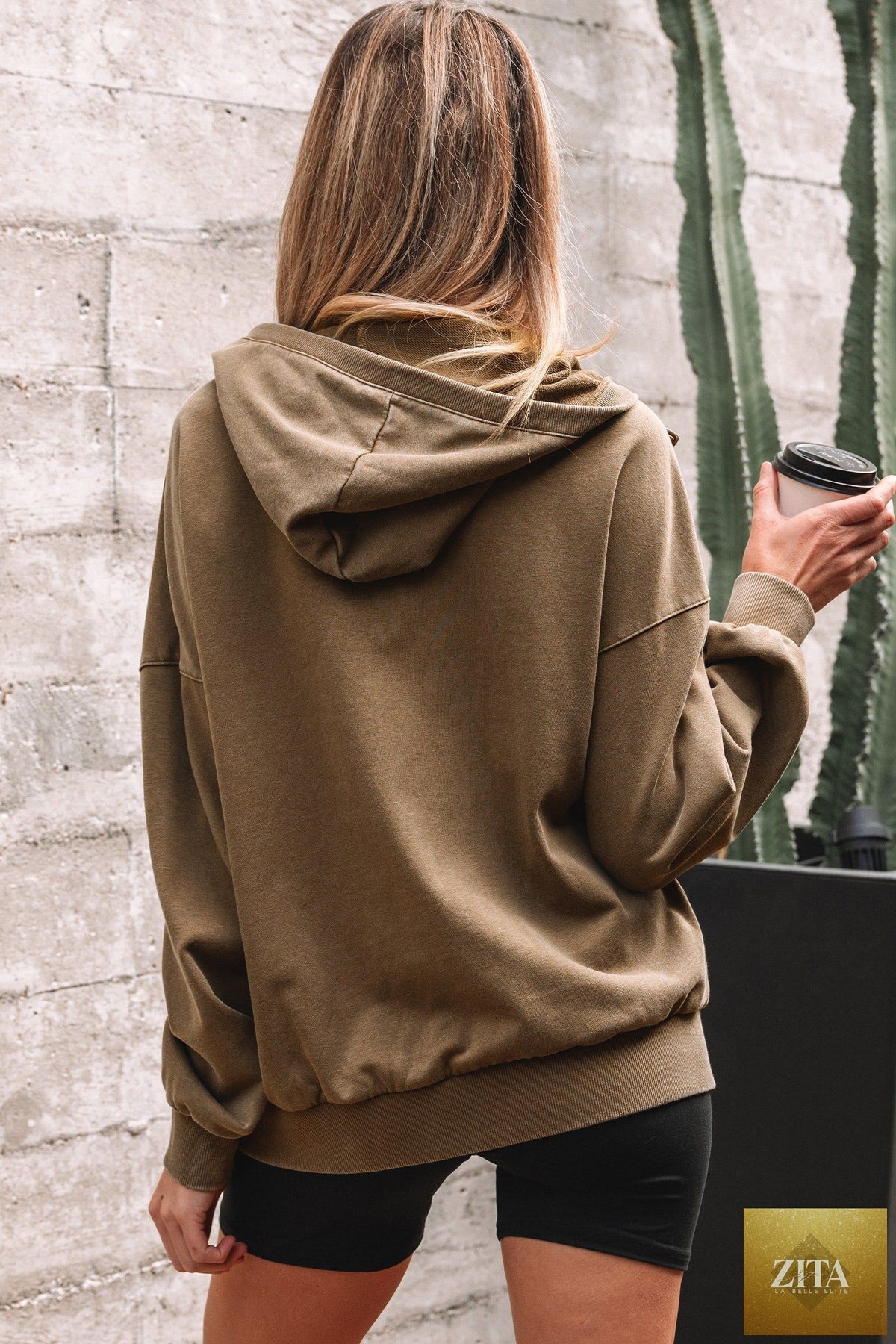 Black half-zip kangaroo pocket mineral wash hoodie from Wild and Free Boutique, featuring a relaxed baggy fit and casual style.
