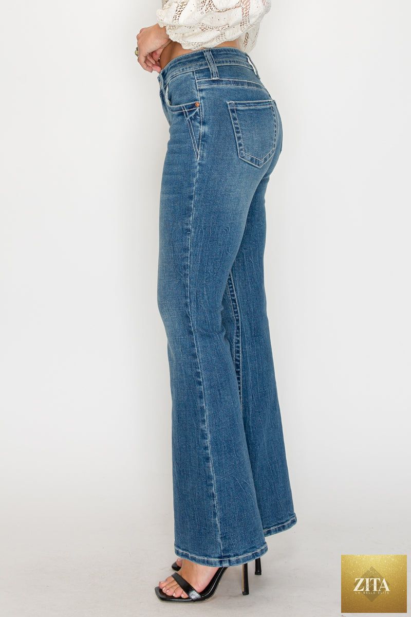 Artemis Vintage Stevie tummy control high rise slim flare jeans in medium wash, showing the fitted waist and flared leg design.