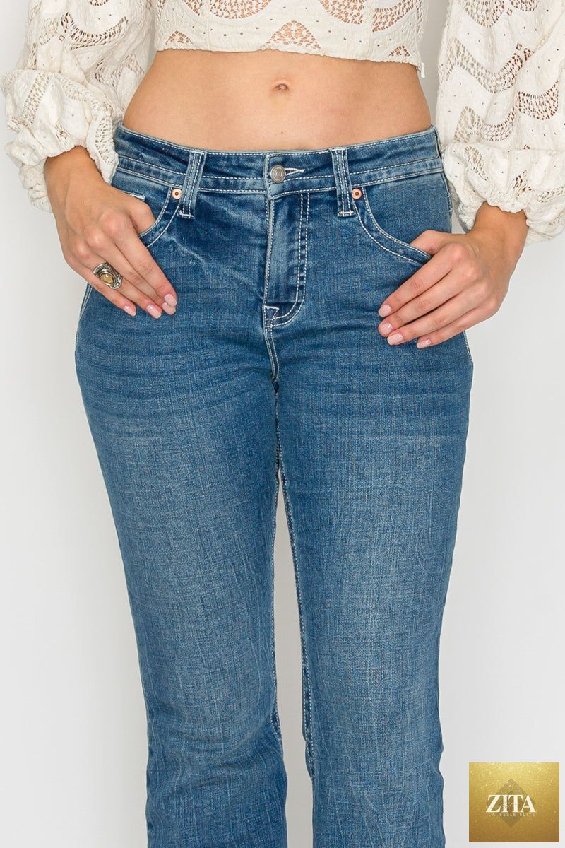Artemis Vintage Stevie high-rise slim flare jeans in medium wash with tummy control and classic denim style.