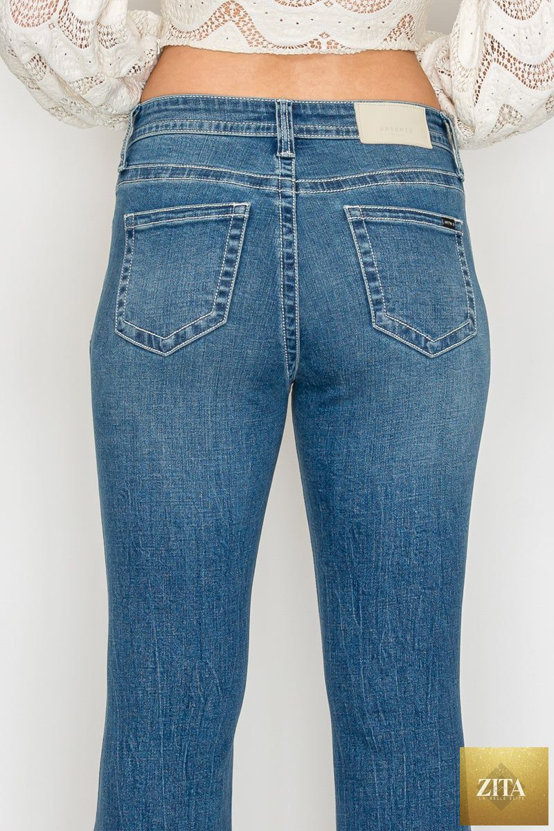 Artemis Vintage Stevie high-rise slim flare jeans in medium wash denim, featuring tummy control and flared leg design.