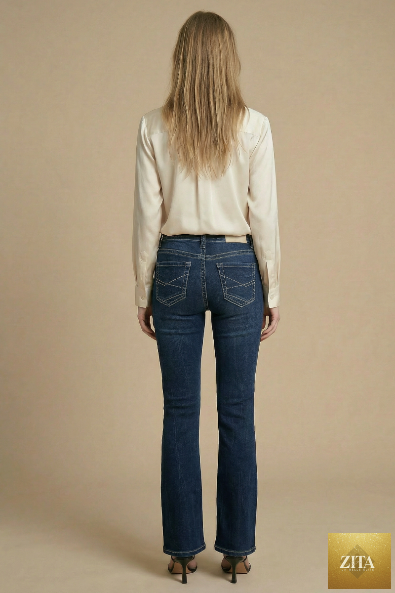 Artemis Vintage Stevie Tummy Control high-rise slim flare jeans in dark wash denim, showcasing a fitted waist and flared leg style.