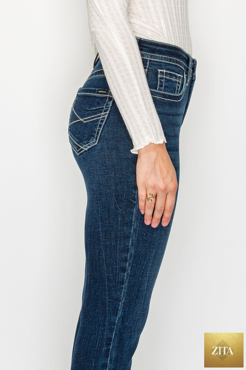 Dark wash Stevie Tummy Control high-rise slim flare jeans by Artemis Vintage, showing a close-up of the fitted waist and flared legs.