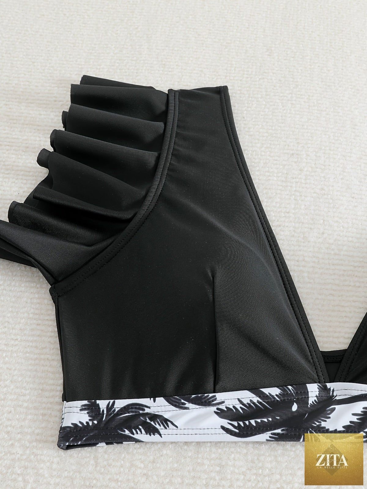 Black ruffle bikini set for women featuring high-waisted bottoms and V-neck top, made of stretchy fabric for beach and poolside wear