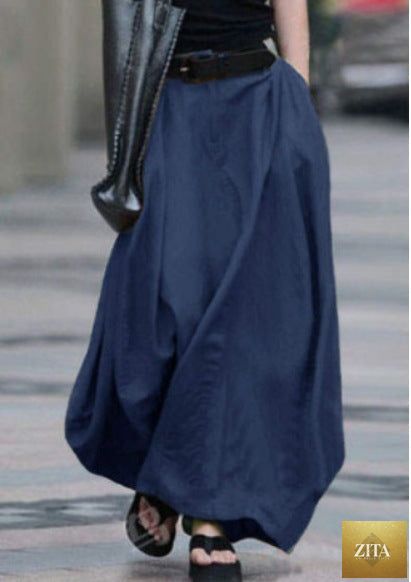 Women's high-waist flared maxi skirt by FitiqueFit in solid cotton linen, featuring side pockets and a flowing silhouette.
