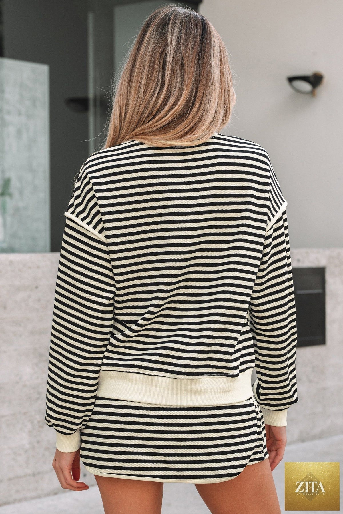 Black stripe textured drop shoulder pullover top and drawstring mini skirt two-piece dress set from Wild and Free Boutique