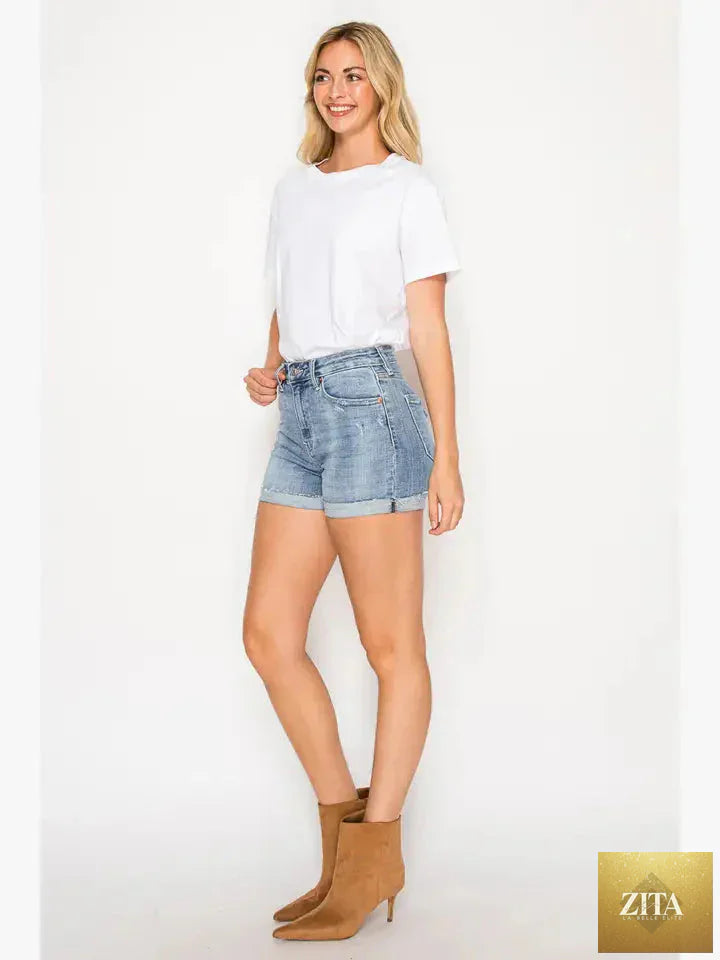 Artemis Vintage Kathy high-rise cuffed stretch shorts in denim, showcasing a relaxed fit with rolled cuffs and distressed detailing.