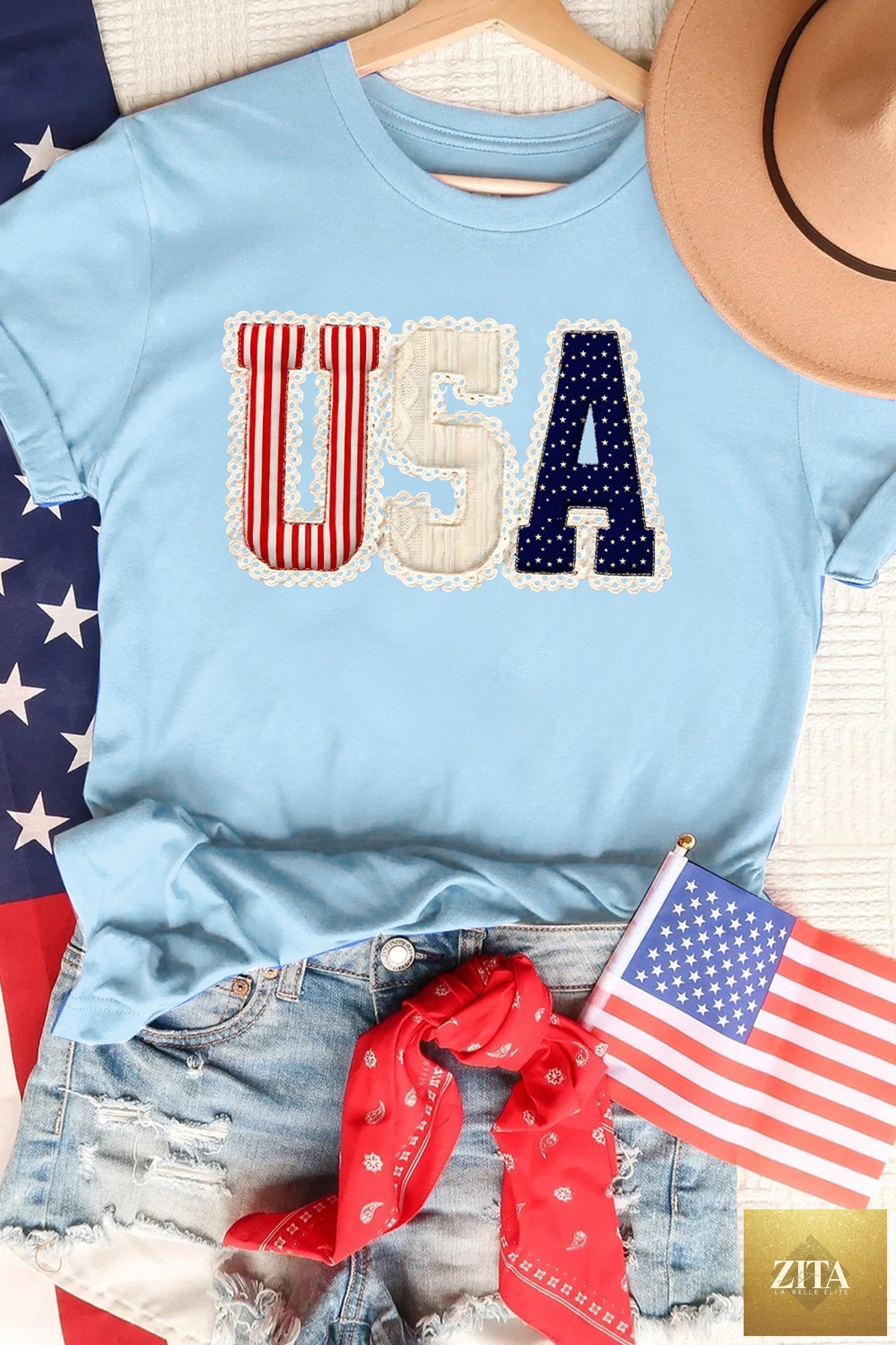 Light blue USA patriotic printed graphic T-shirt from Wild and Free Boutique featuring patriotic American flag design.