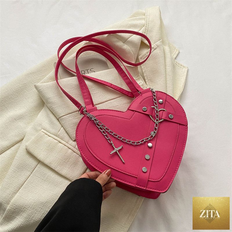 Korean-style cute heart-shaped shoulder crossbody bag from Social Buzz eSIMs, featuring a charming niche design and adjustable strap.