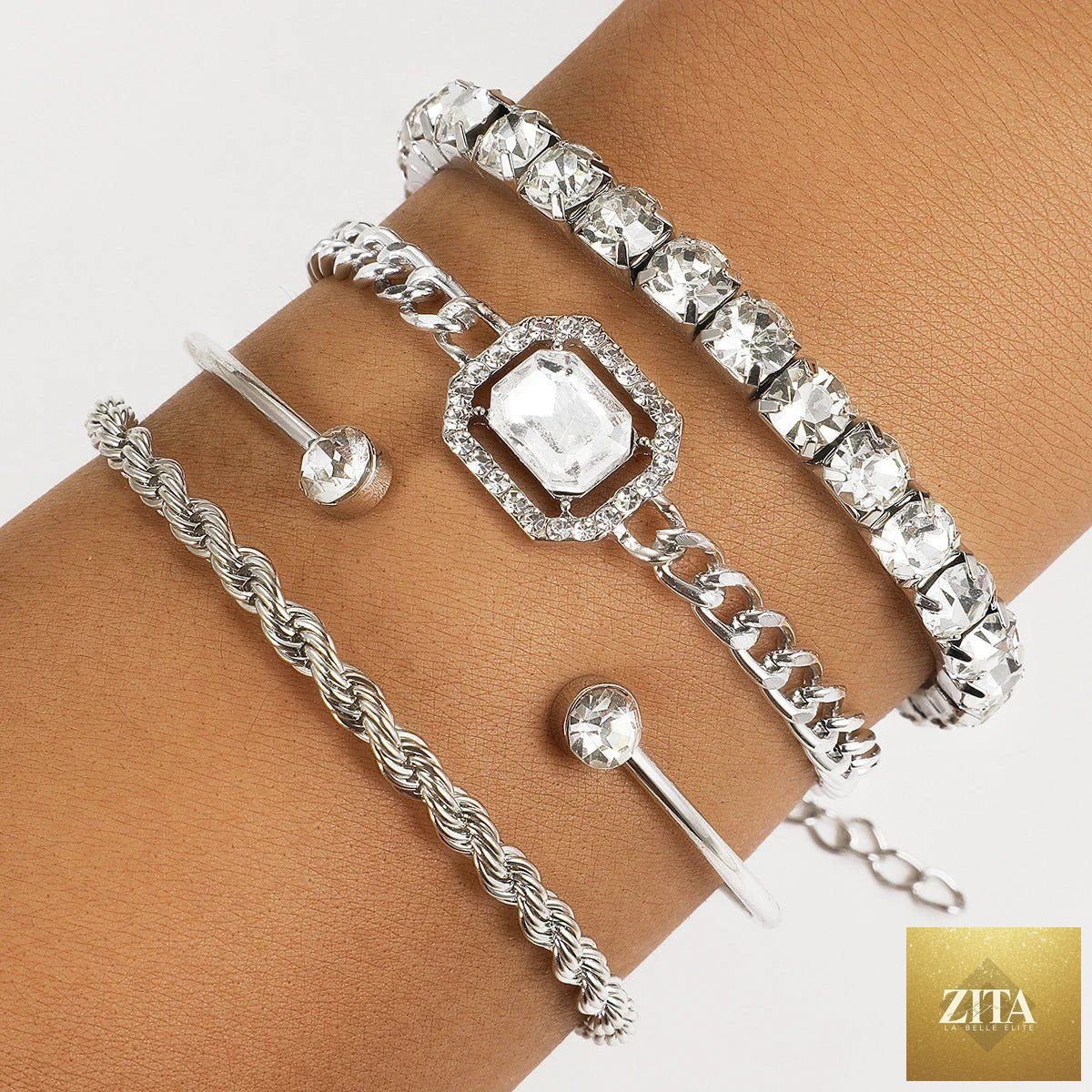 Set of four bohemian-style crystal bracelets by MANDOTOS featuring vintage twisted cuff and chain designs for women.