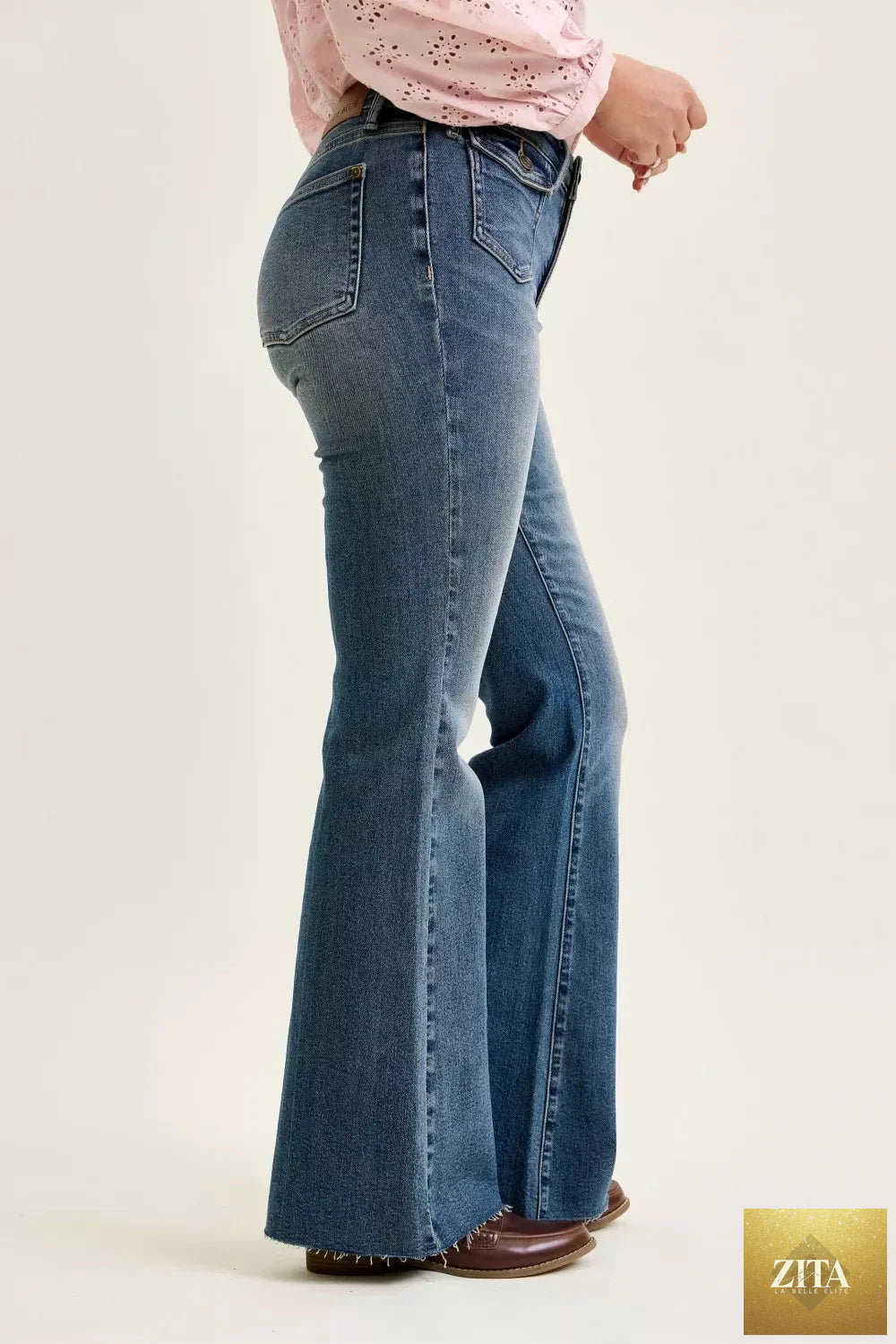 Wild and Free Boutique Judy Blue mid-rise flare jeans with front flap pockets, showcasing stylish denim bottoms.