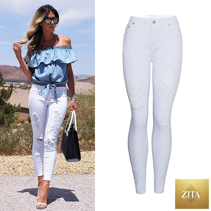 Women's white slim-fit ripped skinny pants by My Store, showcasing their solid color, ripped design, and snug fit.