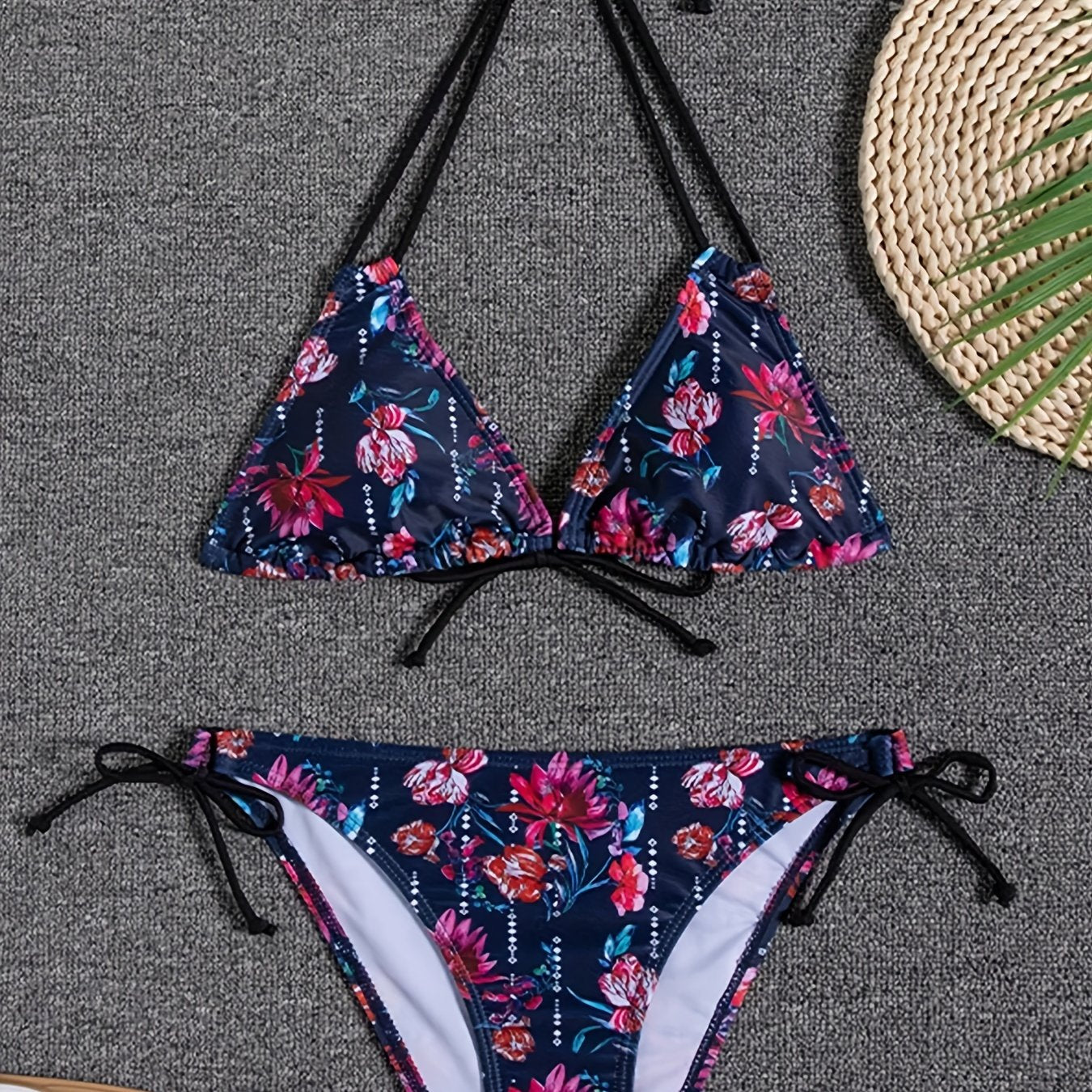Stevvex Sunset Bloom 2-piece bikini set with vibrant floral print, halter neck, tie-back top, and high-cut tie-side bottoms for women.