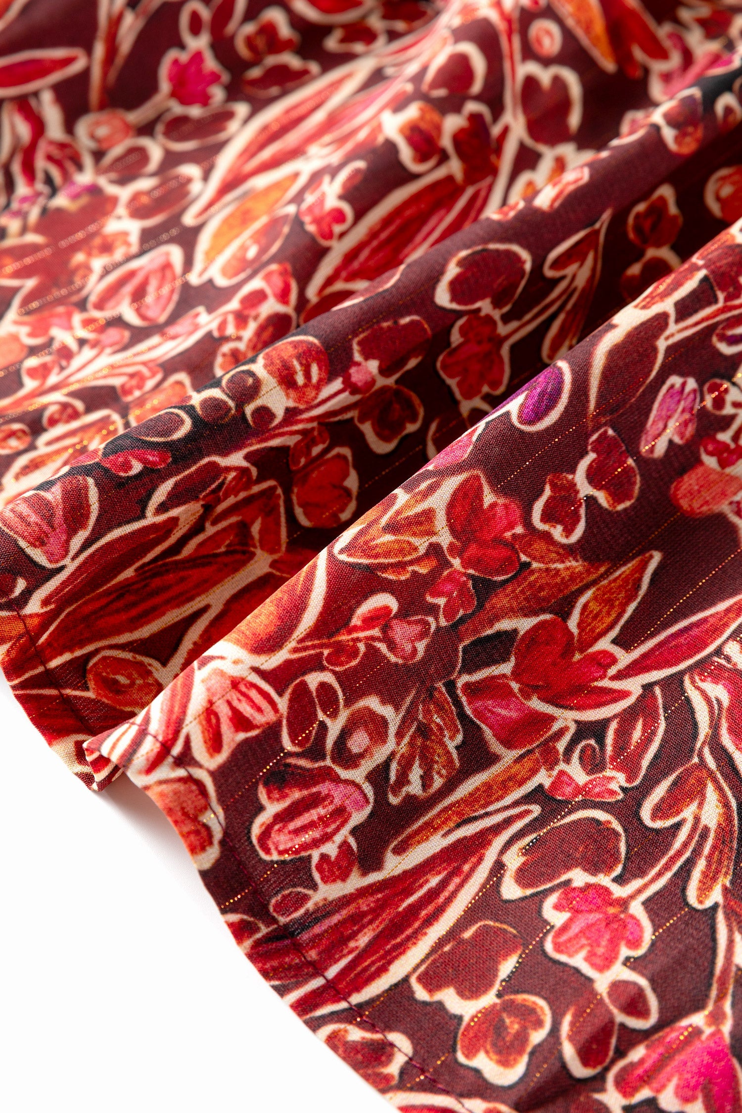 Red floral print long sleeve mini dress with shirred high neckline and loose fit from Wild and Free Boutique.