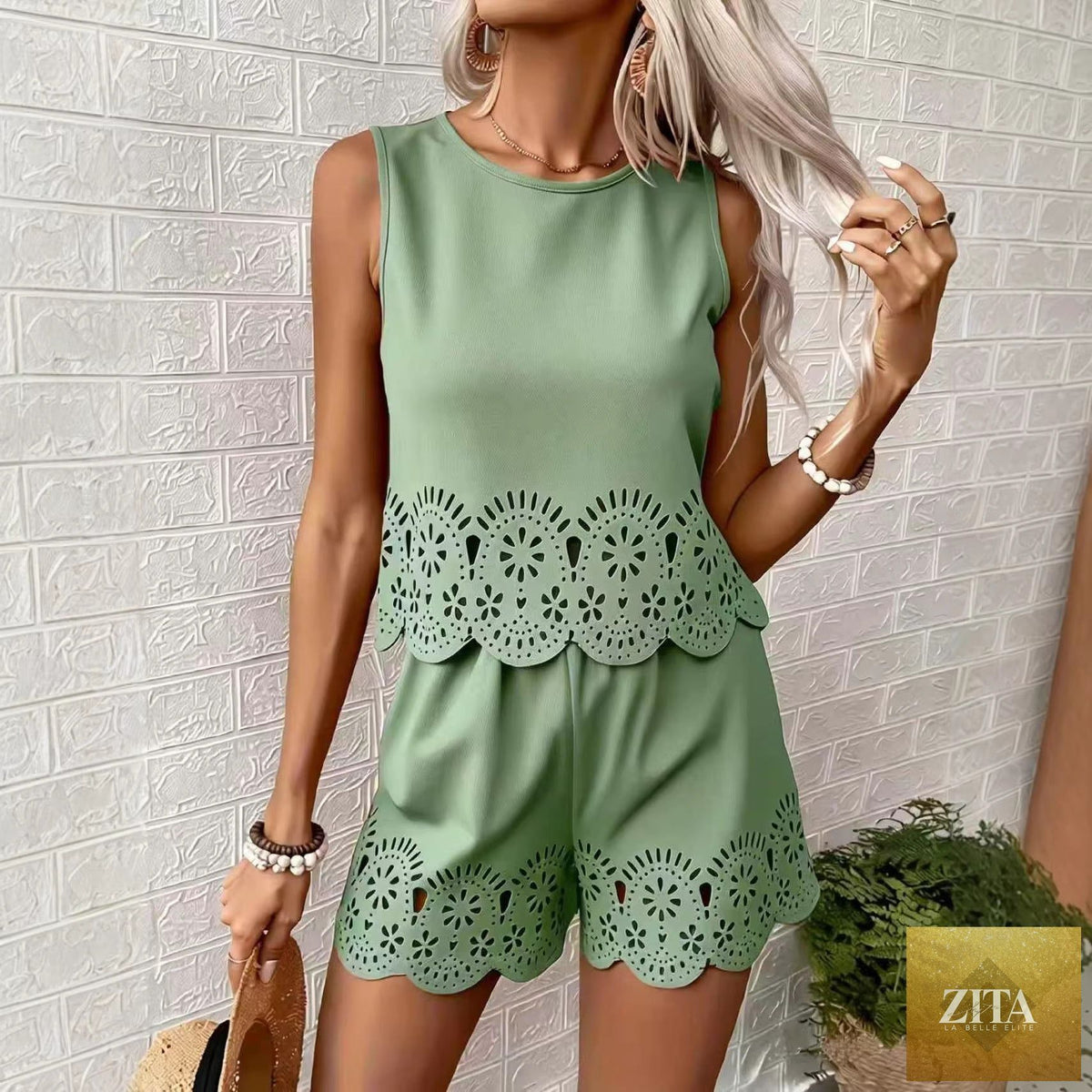 Women's elegant hollow-out floral top and pants set by Zita La Belle Elite, casualwear with intricate floral cutouts.