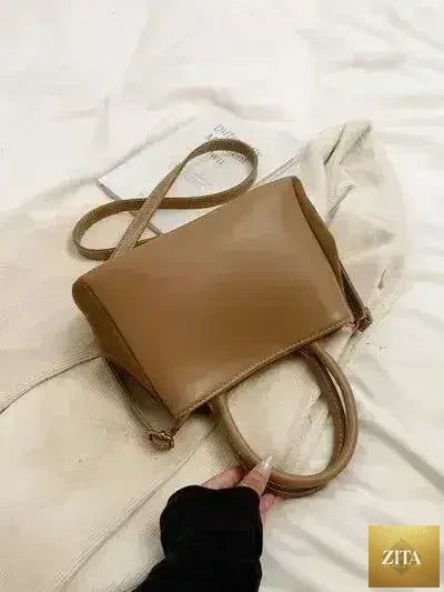 Femstylo stylish suede handbag with adjustable strap, featuring a versatile dual-use design and sleek, modern look.