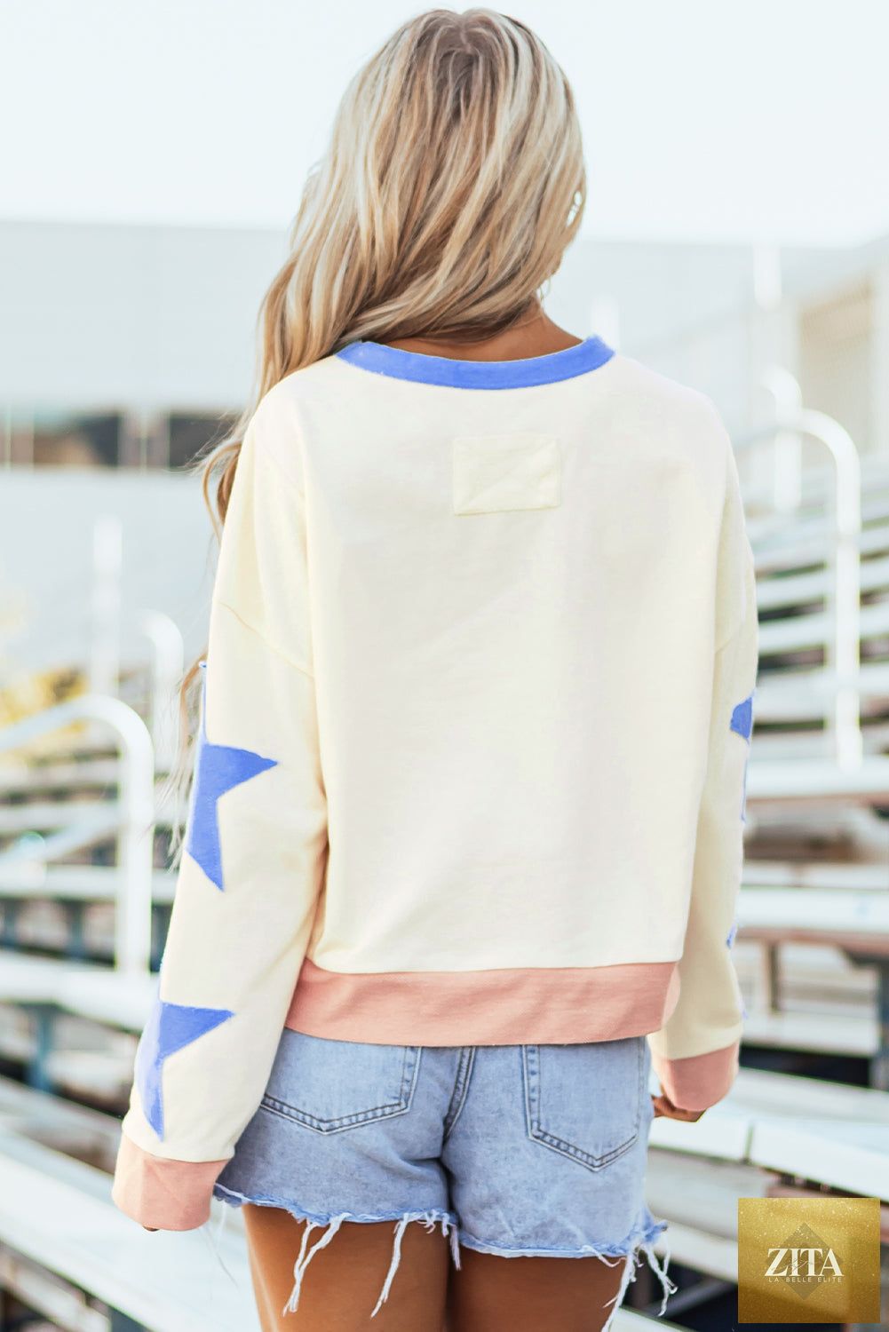 Beige star patchwork oversized sweatshirt with exposed seams from Unique Oils, featuring a relaxed fit and stylish design.