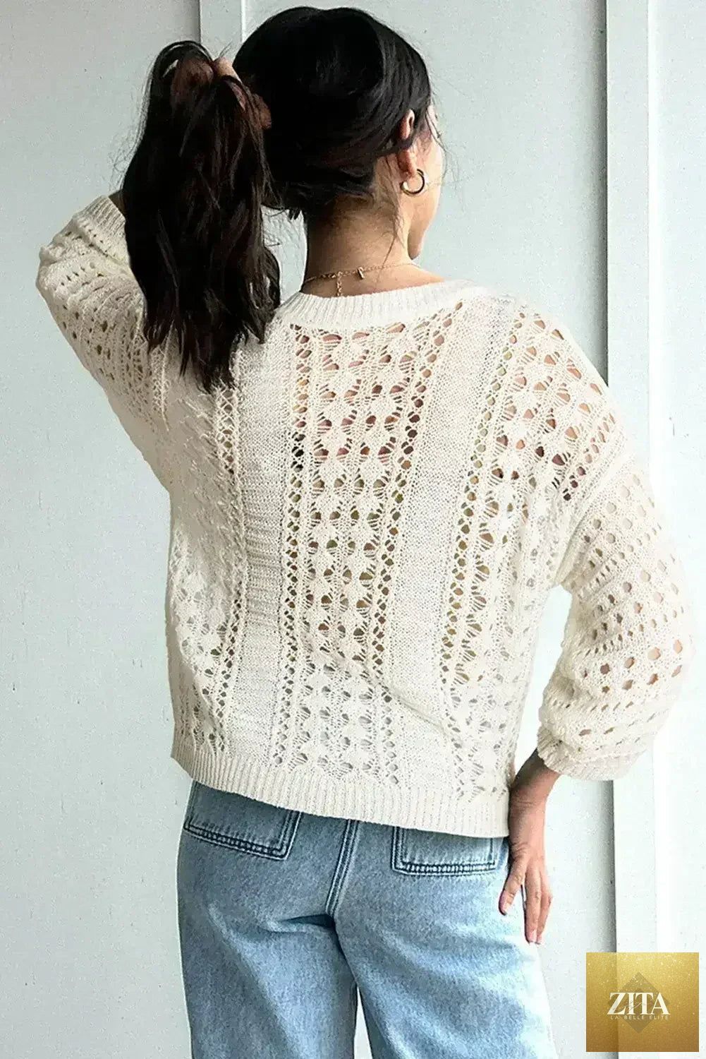 White hollow-out knit sweater with drop shoulder design and bracelet-length sleeves by Femstylo, showcasing a cozy, stylish fit.