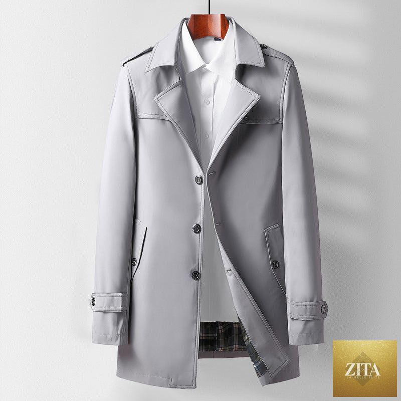 Mid-length beige trench coat with lapel collar, stylish and versatile for casual wear, worn by a young woman.