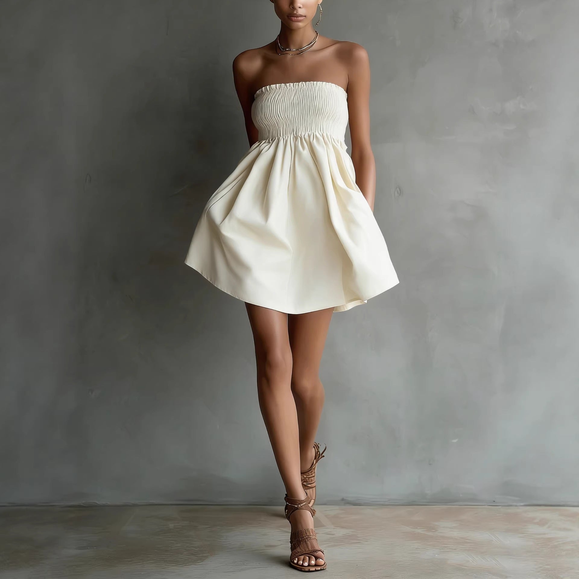 Women's strapless tube mini dress by FitiqueFit in solid color with elastic waist, casualwear style, shown on a model.