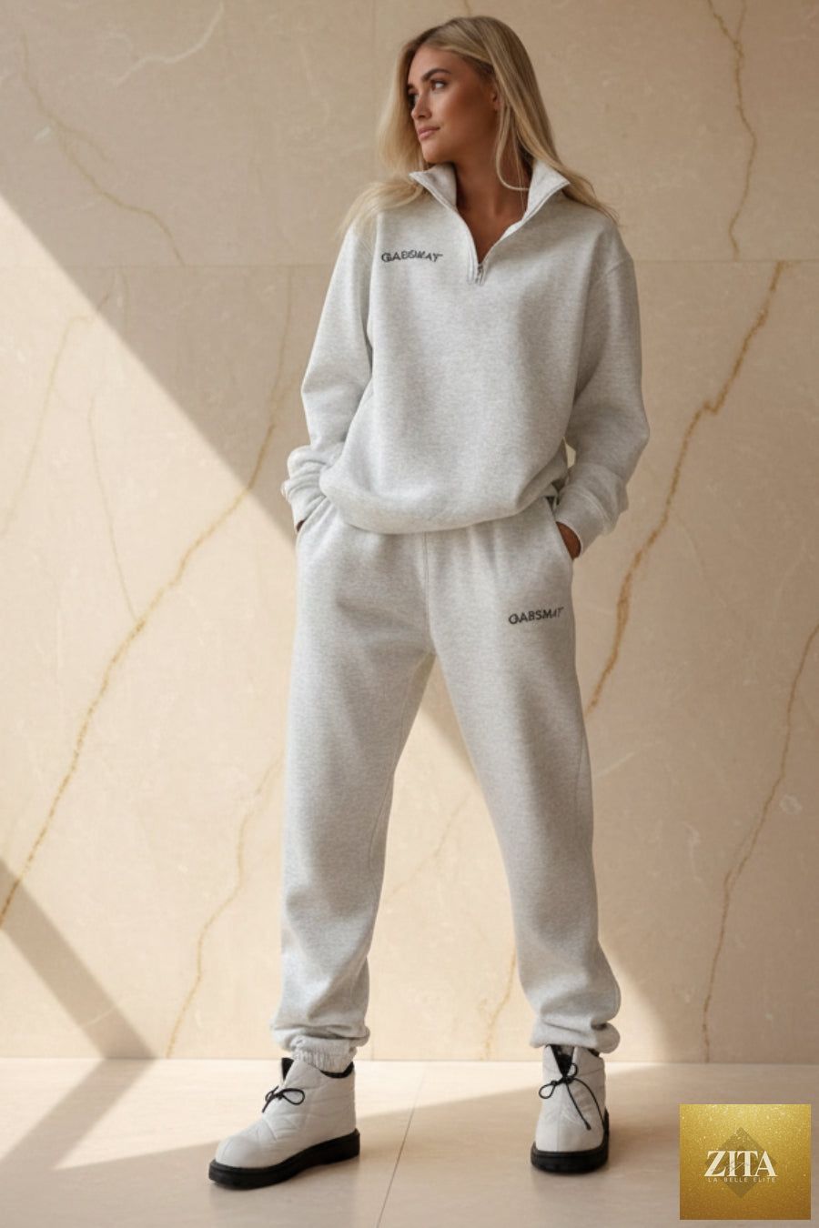 Women's embroidered half-zip sweatshirt and jogger pants set by MERIDGE, casual two-piece activewear outfit in soft fabric.