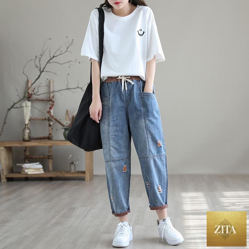 Women's summer ripped jeans by FitiqueFit, showing distressed denim style with frayed hems and ripped details.