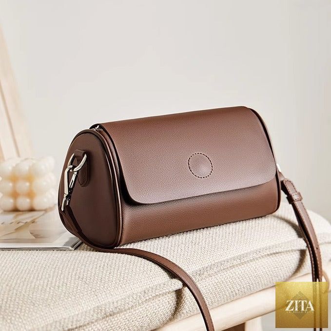 Elegant genuine leather mini round handbag tote for women, featuring a shoulder strap and stylish design.