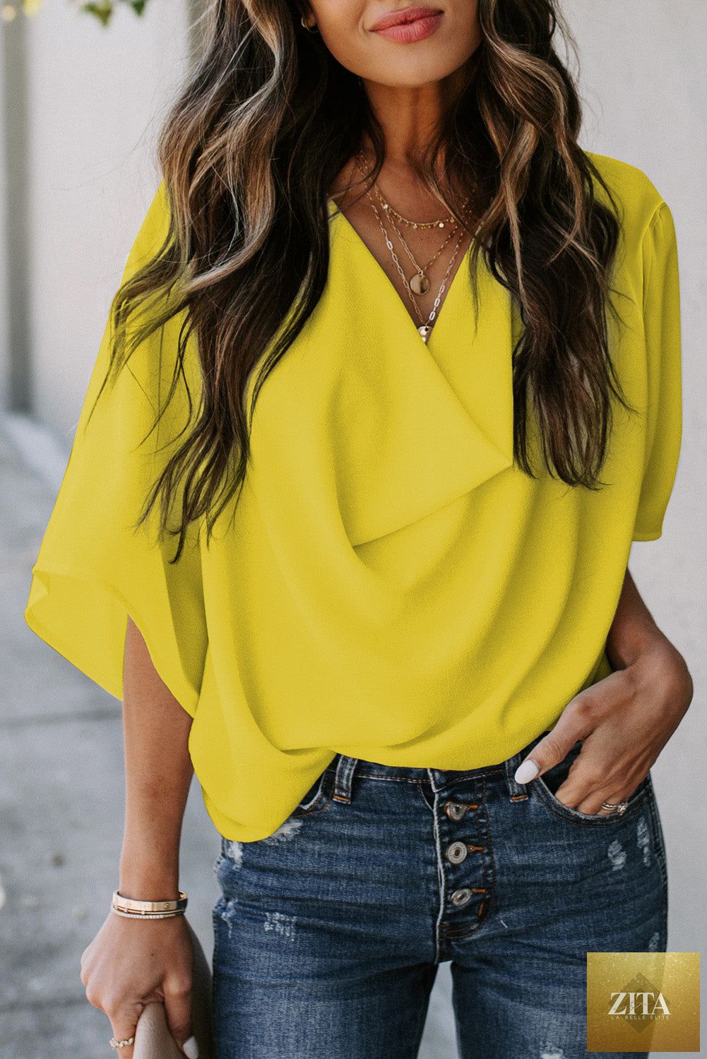 Golden Glow women's casual summer wrap blouse with V-neck and draped sleeves, stylish and comfortable from Wild and Free Boutique.