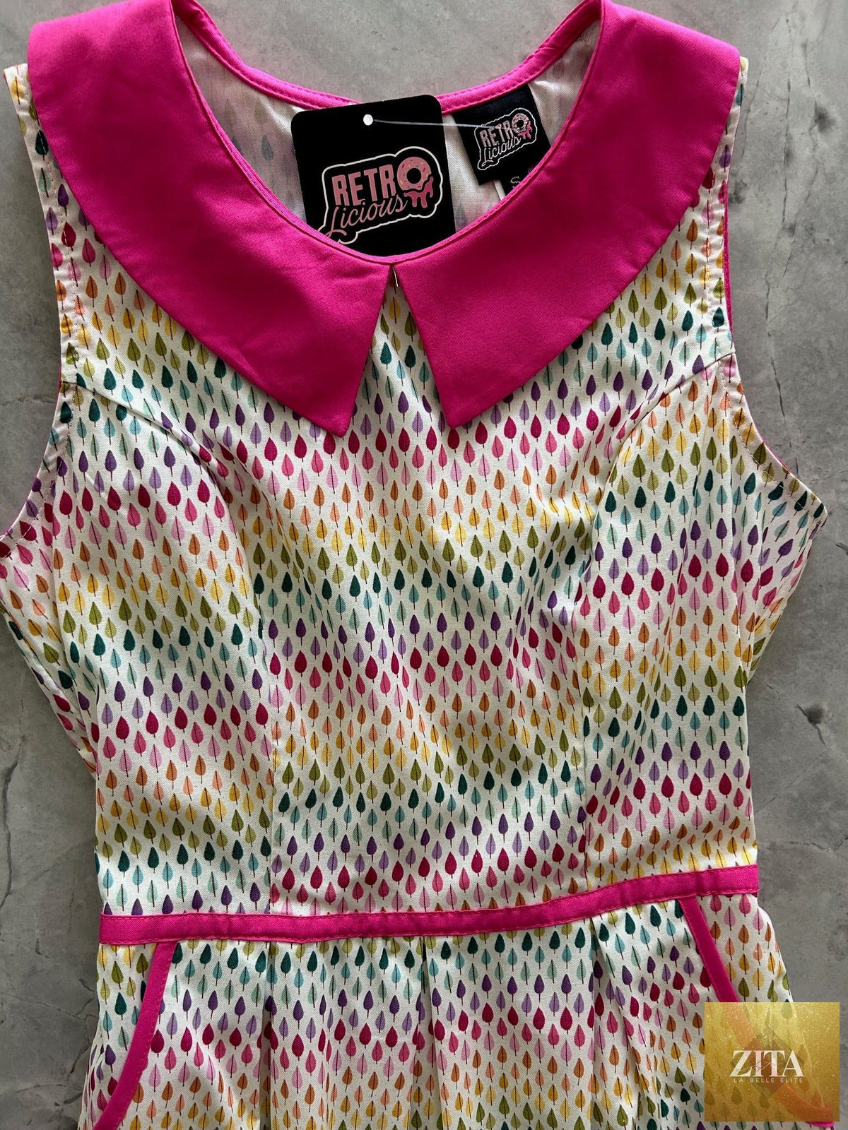 Retrolicious Rainbow Drop Collared Dress featuring a colorful, vintage-inspired design with a pointed collar and short sleeves.