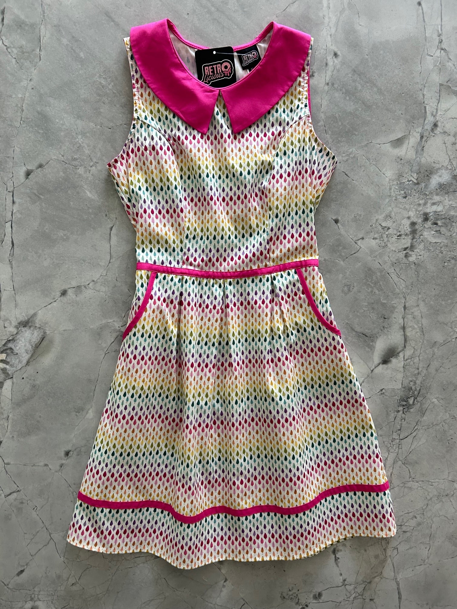 Rainbow Drop collared dress by Retrolicious, featuring vibrant rainbow colors, a collared neckline, and a stylish fit.