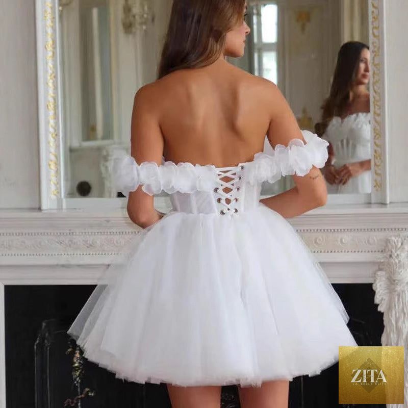 Lace off-shoulder mini wedding dress with fitted bodice and flowy skirt, perfect for bridal occasions.