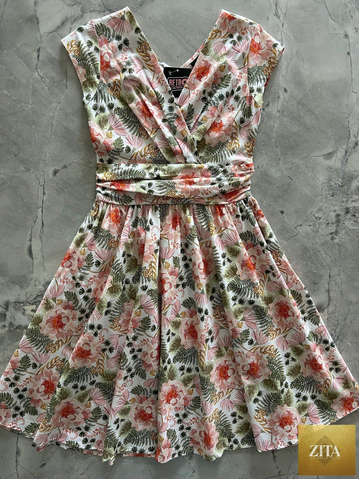 Pink floral Greta dress by Retrolicious, showcasing a vintage-inspired dress with a fitted waist and flowy skirt.
