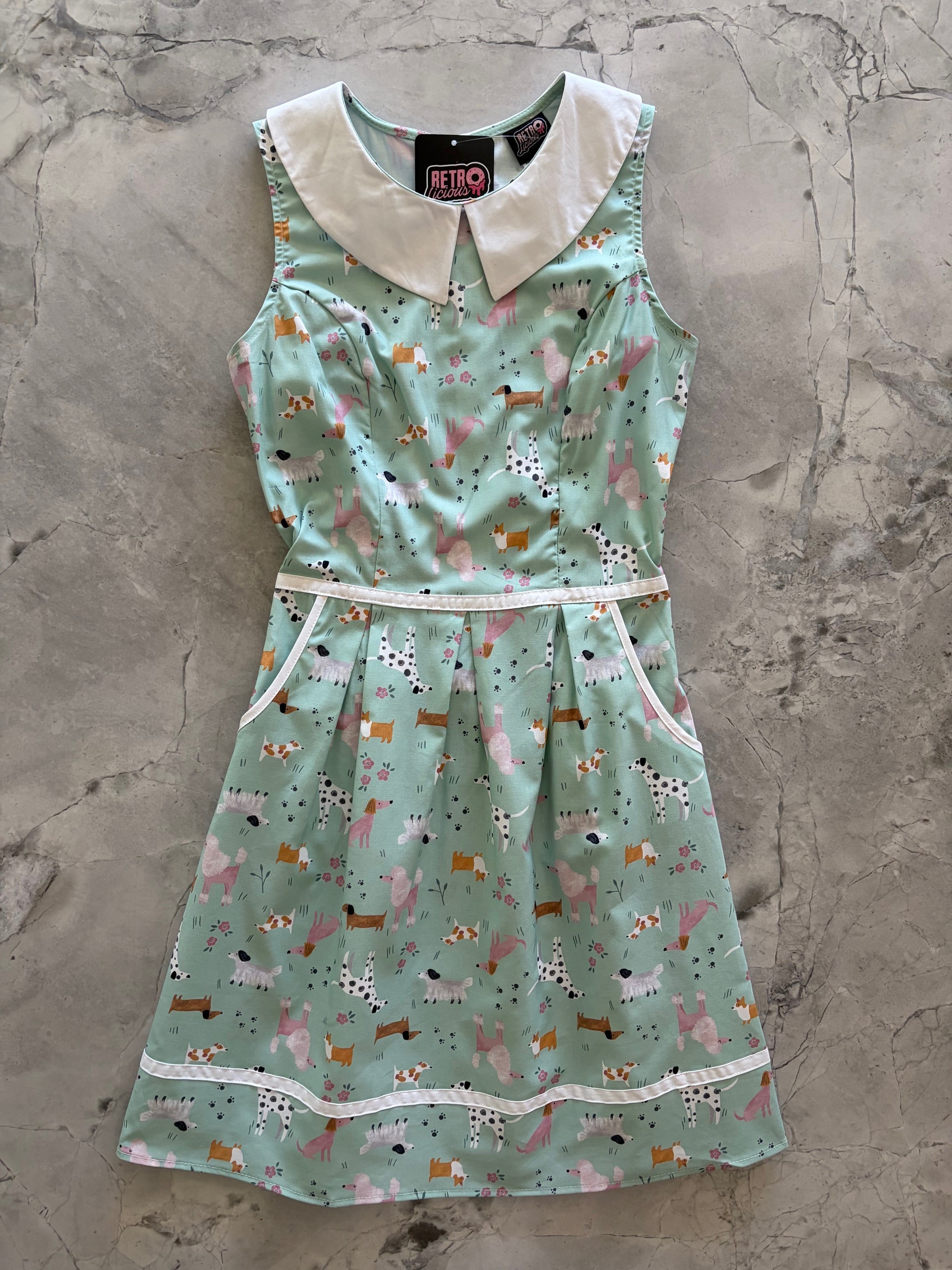 Retrolicious dogs collared dress with polka dot pattern, lightweight fabric, and bow detail, suitable for small pets or fashion accessories.