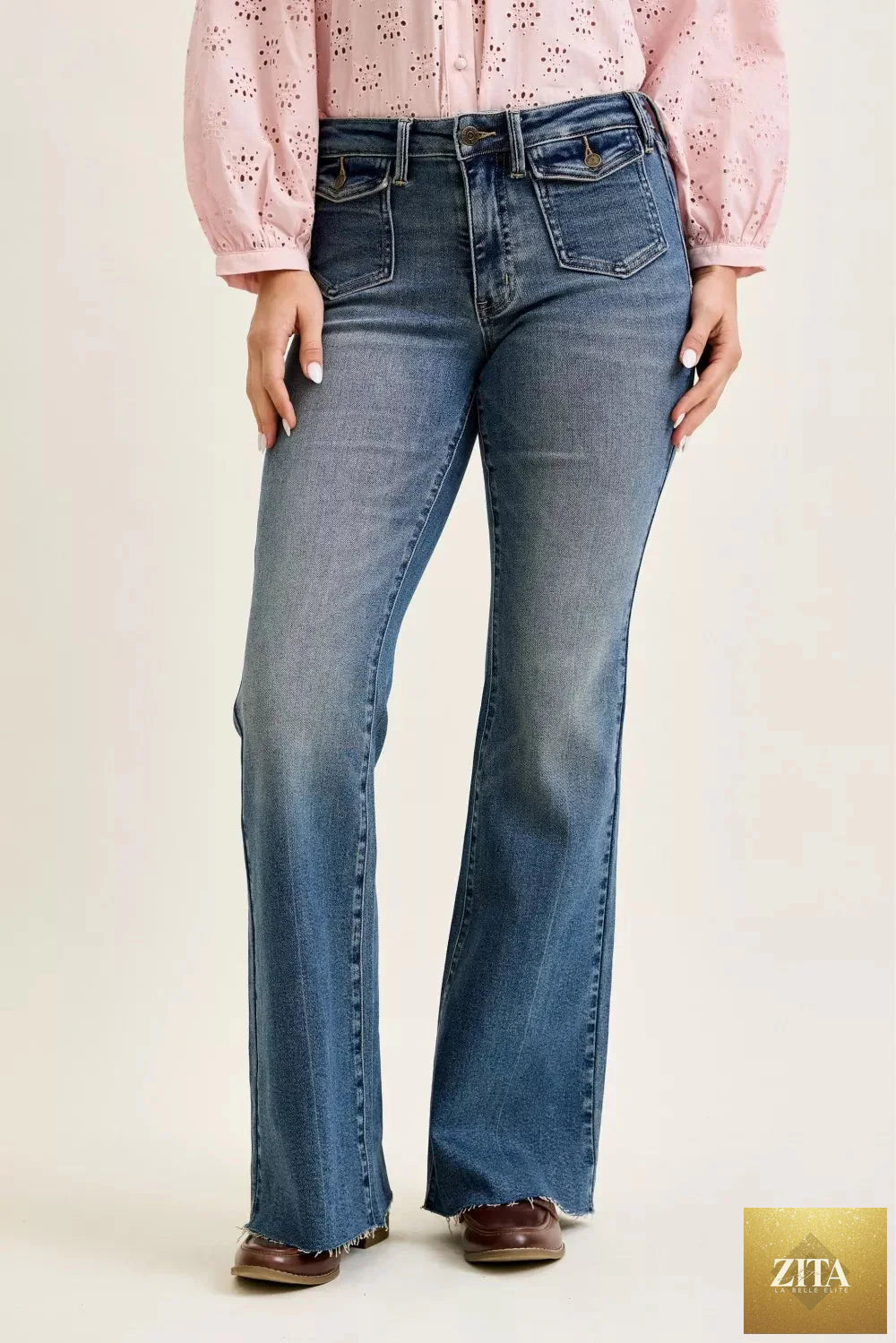 Wild and Free Boutique Judy Blue mid-rise flare jeans with front flap pockets, showcasing classic denim style and casual fit.
