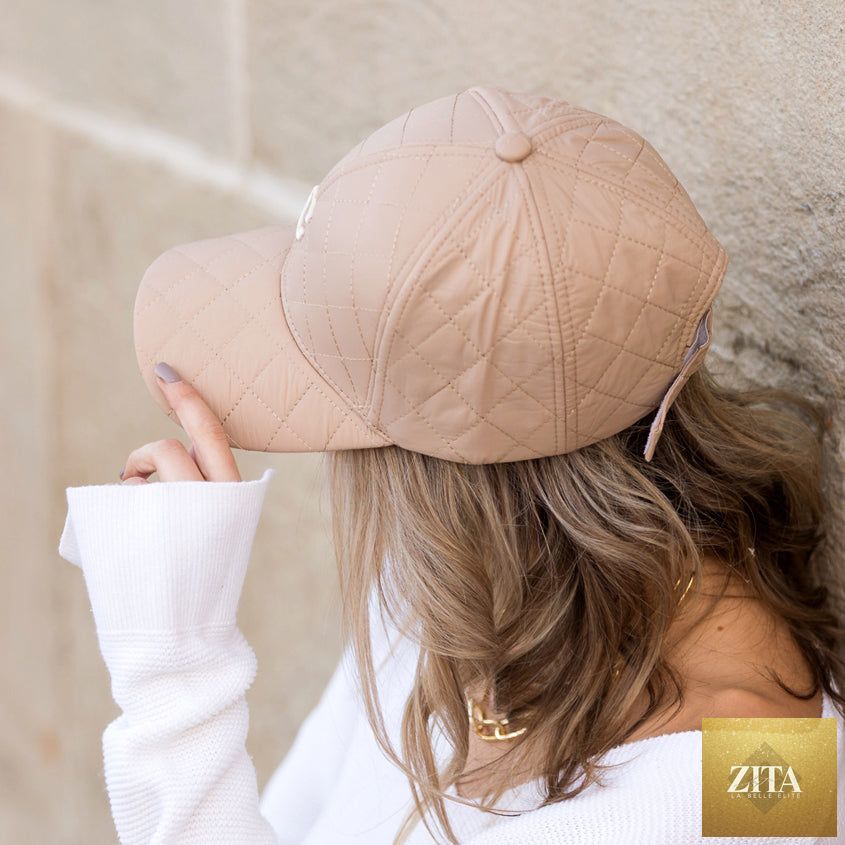 Aili's Corner quilted puffer ball cap featuring a rounded baseball cap design with quilted stitching and a curved brim.