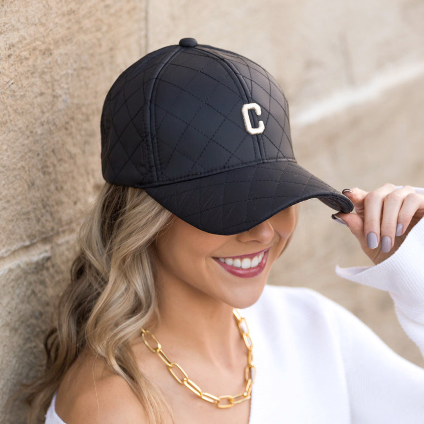 Aili's Corner quilted puffer baseball cap in neutral tones, featuring a rounded crown and curved brim for casual style.