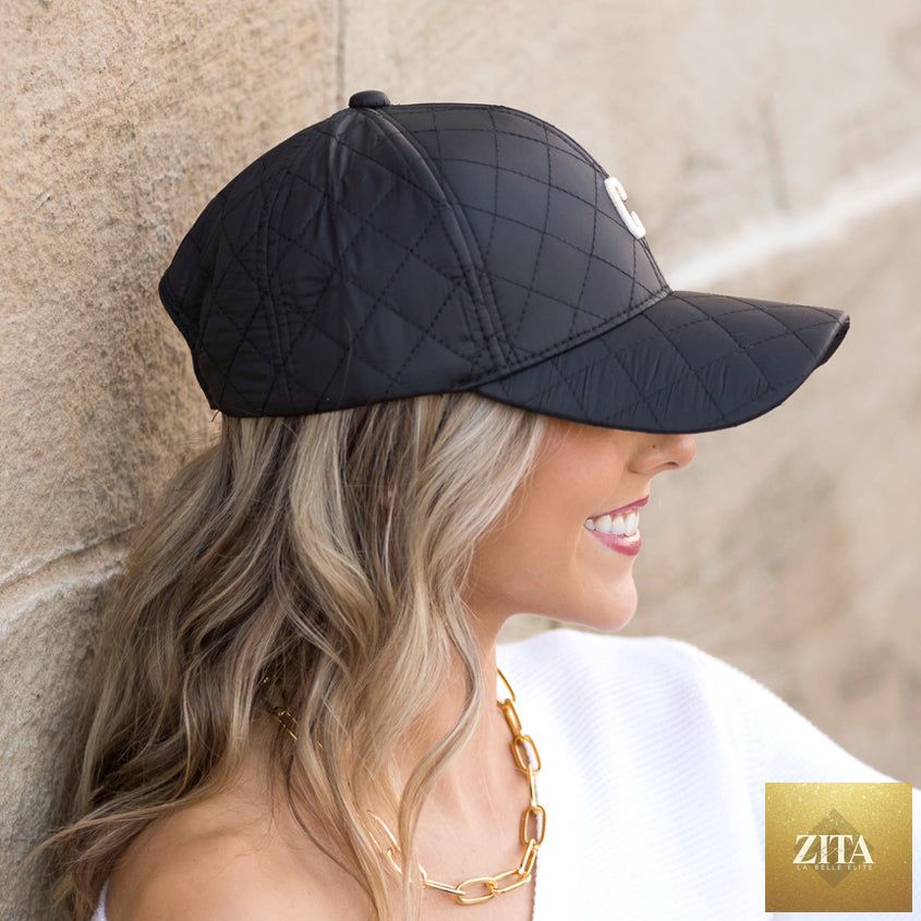 Aili's Corner quilted puffer baseball cap with a rounded brim and stitched quilted pattern, stylish and warm headwear.