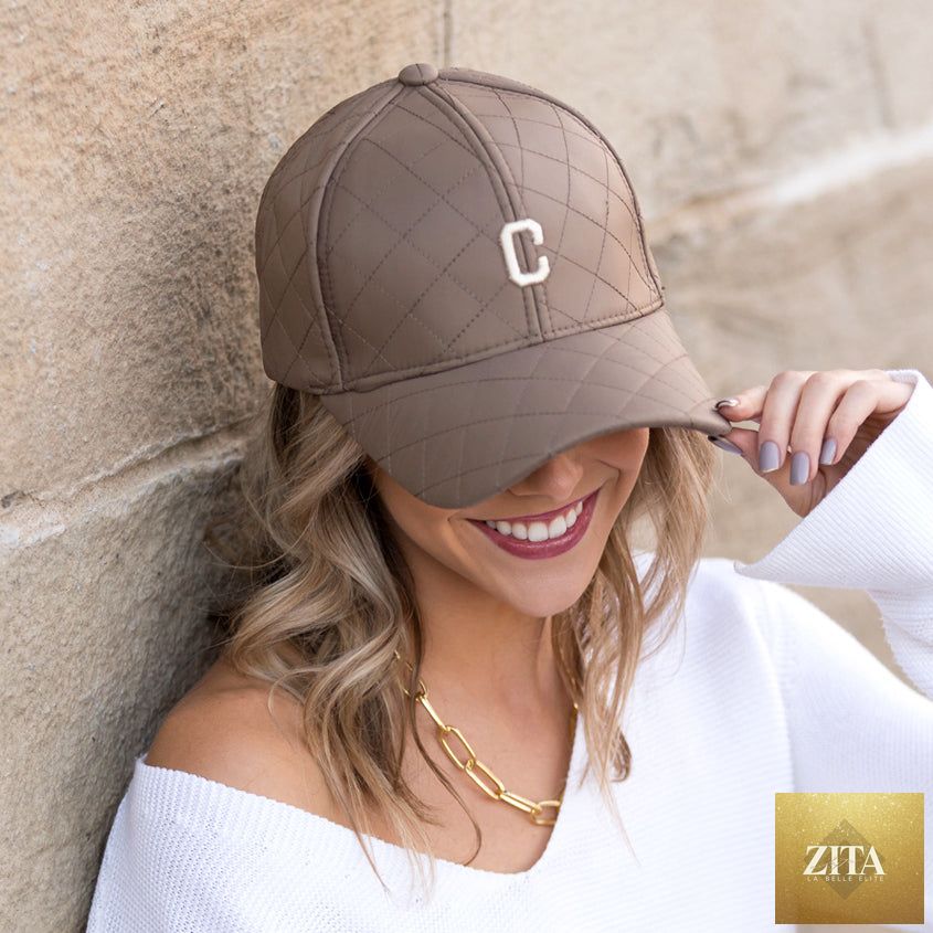 Aili's Corner quilted puffer baseball cap in black with a rounded brim and quilted padding, stylish and warm headwear.