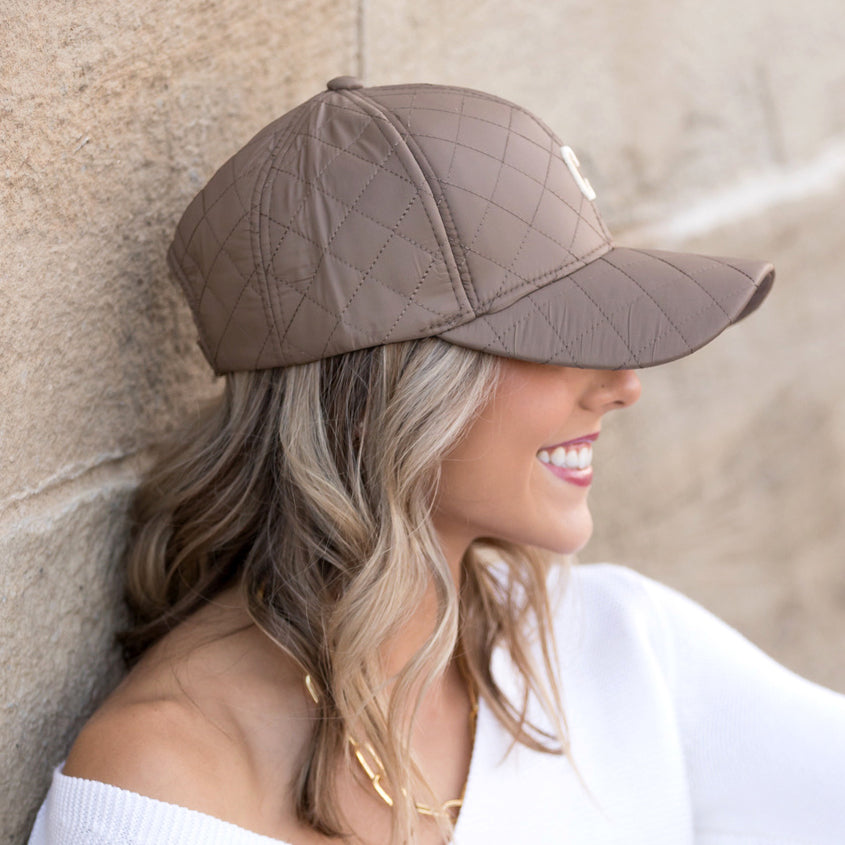 Aili's Corner quilted puffer ball cap, a stylish baseball cap with padded quilted design, displayed on a neutral background.