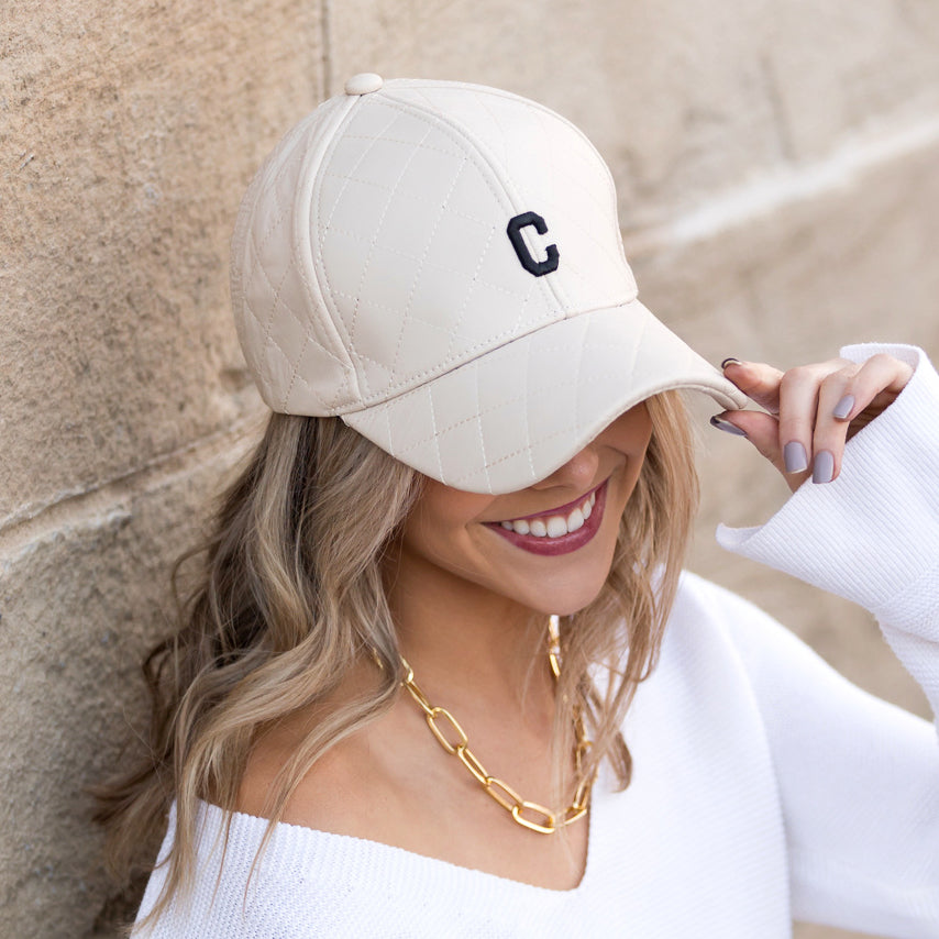 Aili's Corner quilted puffer baseball cap with a rounded brim and quilted design, stylishly displayed on a neutral background.