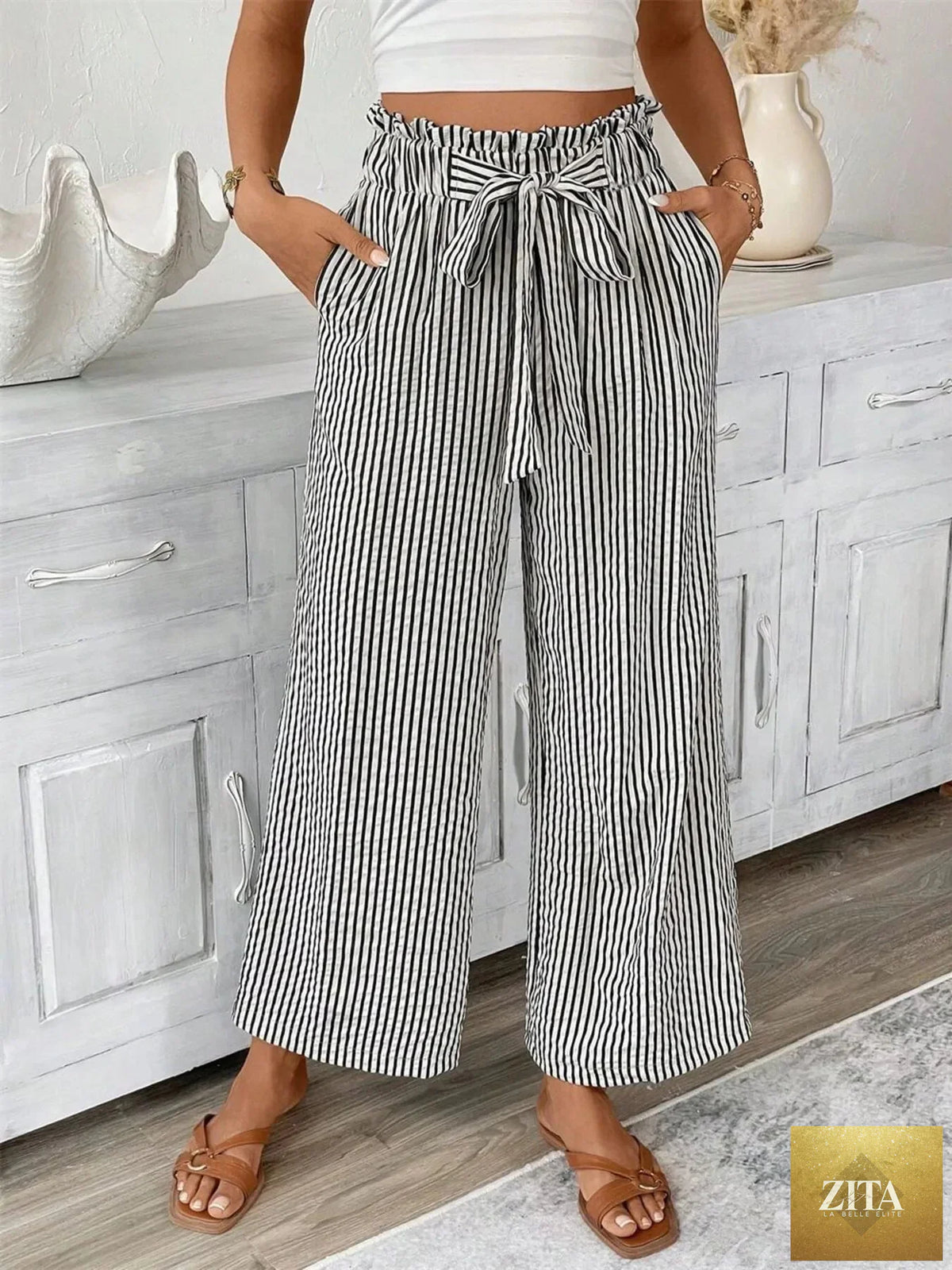 Plus size SITRA striped wide leg paper bag pants with high waist and relaxed fit, featuring bold vertical stripe pattern.