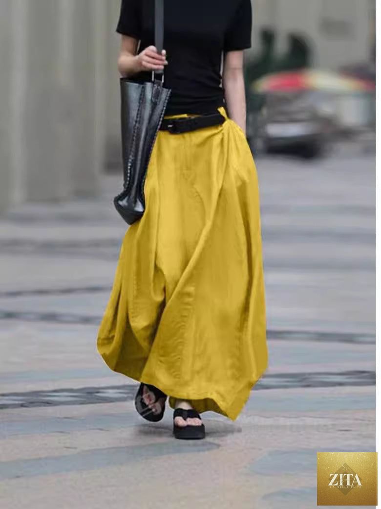 Women's high-waist flared maxi skirt in solid cotton linen with pockets, by FitiqueFit, showcasing its flowy design and comfortable fit.
