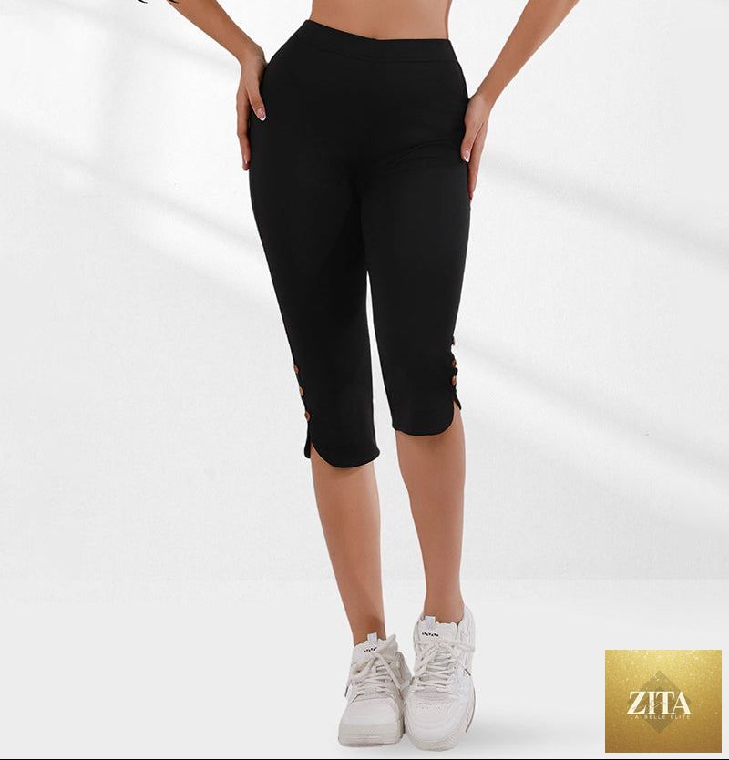 Black women's high-waisted slim Capri pants with slit hem from FitiqueFit, featuring a fitted silhouette and stylish ankle slits.