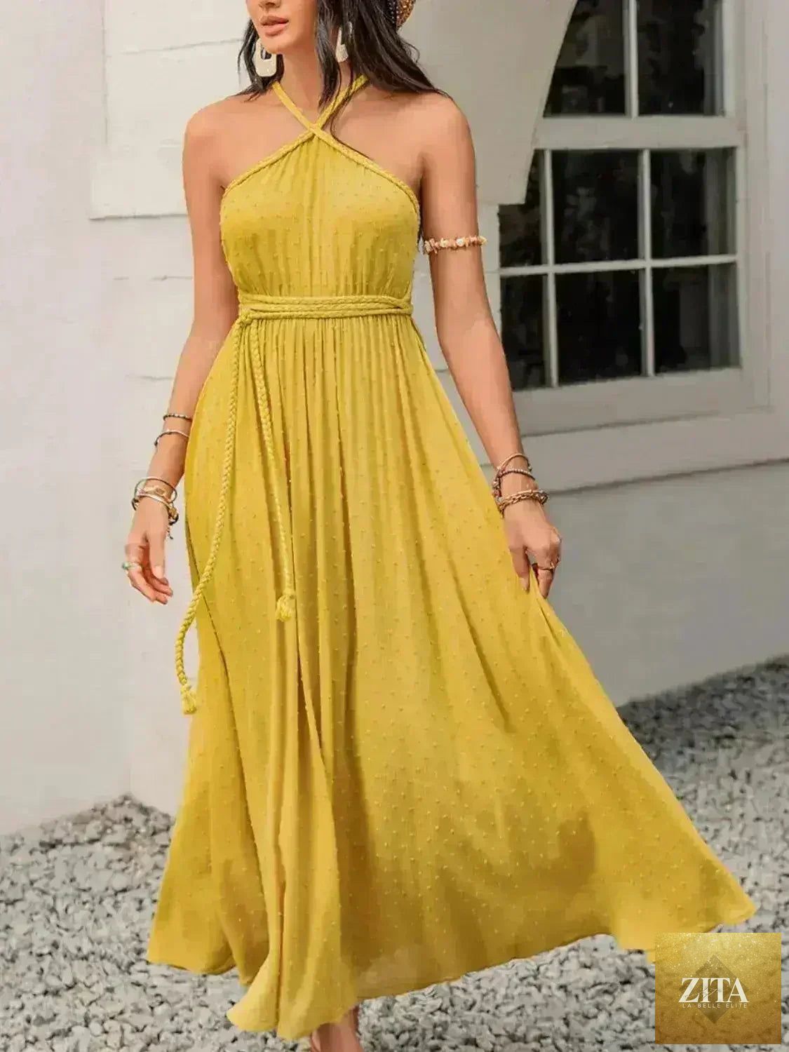 Femstylo women's Swiss Dot backless dress with tied detail and flowy silhouette, showcasing a stylish and elegant summer outfit.