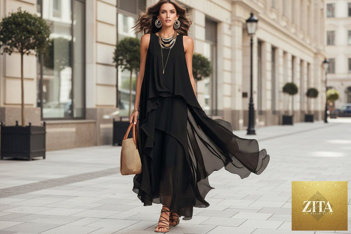 Black asymmetrical ruffle mesh chiffon sleeveless maxi dress by FitiqueFit, featuring flowing fabric and elegant design.